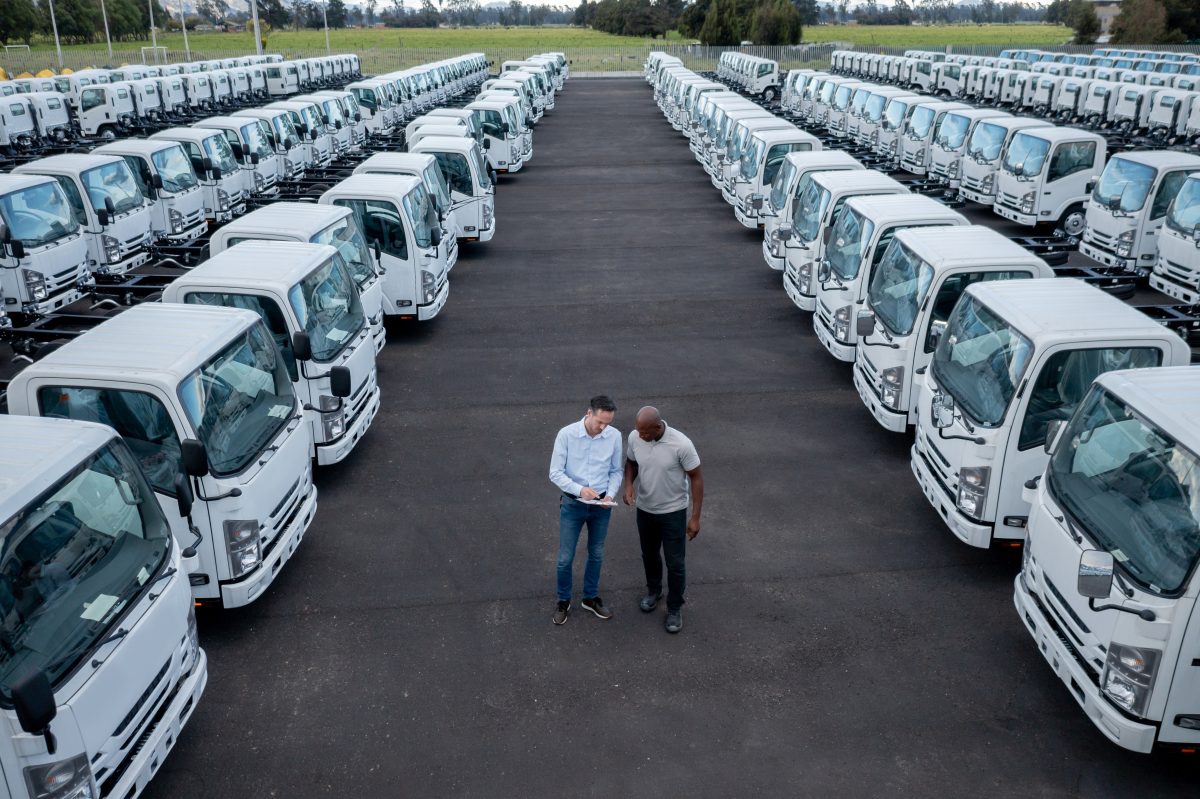 Salesperson with a client at a commercial truck dealership
